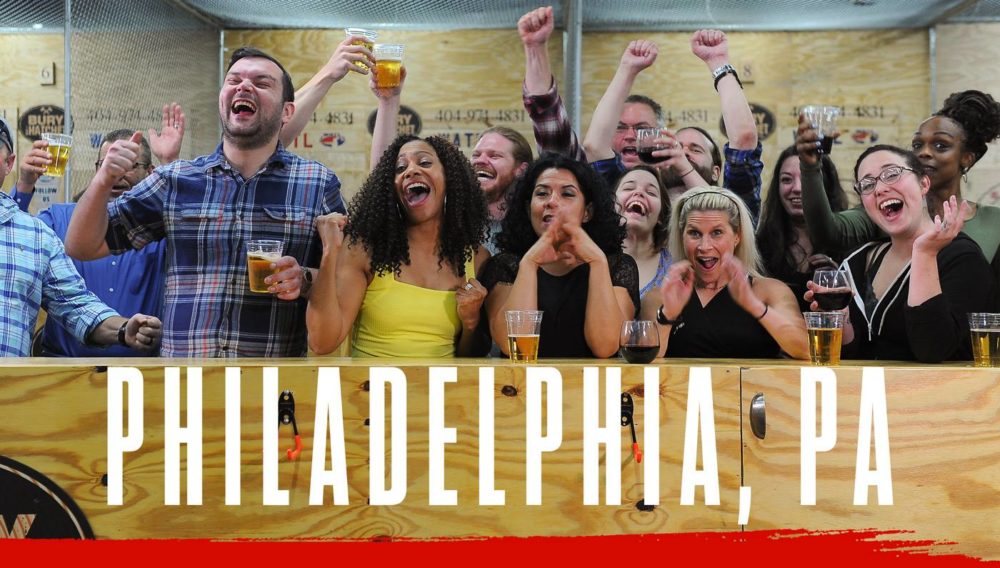 Bury The Hatchet Philadelphia PA City Page Header Image. Axe throwers celebrating with hands in air