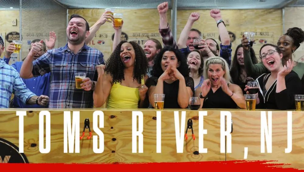 Bury The Hatchet Toms River NJ City Page Header Image. Axe throwers celebrating with hands in air