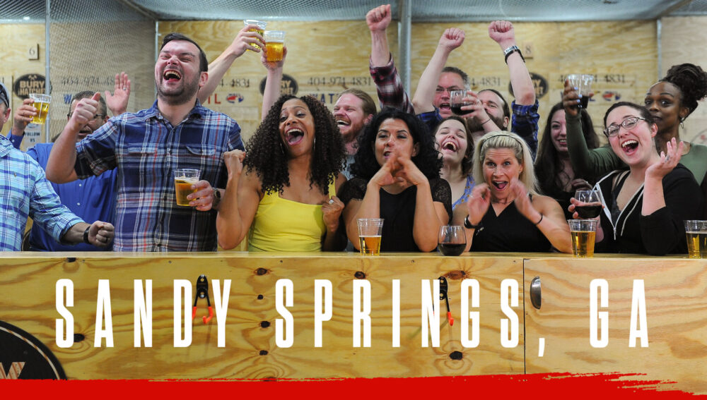 sandy springs georgia header image people cheering while watching axe throwing